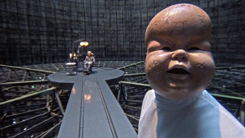 Creepy baby torture mask Brazil movie backdrop