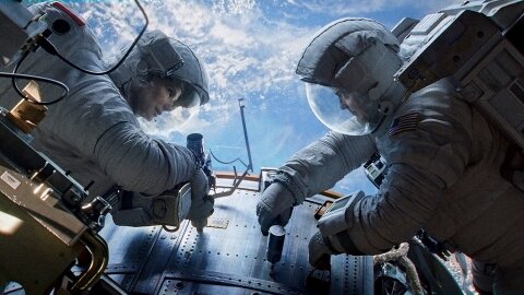 Astronauts working on Hubble with no danger in sight, Gravity backdrop