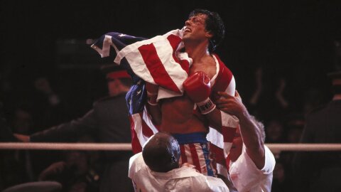Rocky, morally victorious, draped in the American flag