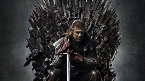 Eddard Stark sitting solemn on the Iron throne