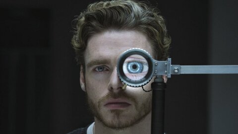 Rob Stark, but in the future, doing an eye test. Oasis tv pilot backdrop.