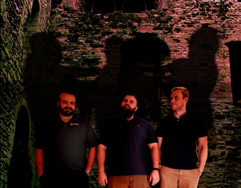 Decipher SciFi co-hosts standing in a gloomy castle with their shadows fighting as in the movie Bram Stoker's Dracula